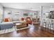 Open living space features hardwood floors, a comfy sofa, and a dining area, perfect for modern living at 6453 5Th N Ave, St Petersburg, FL 33710