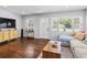 Cozy living room featuring hardwood floors, stylish furniture, and ample natural light at 6453 5Th N Ave, St Petersburg, FL 33710
