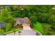 This home features a well-manicured lawn, screened in pool, and mature trees at 7244 Wild Oak Ln, Land O Lakes, FL 34637