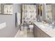 Cozy bathroom featuring shower/tub combo with charming nautical themed shower curtain and neutral vanity at 7244 Wild Oak Ln, Land O Lakes, FL 34637