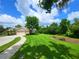 Expansive front lawn with lush landscaping frames this beautiful home with a three-car garage at 7244 Wild Oak Ln, Land O Lakes, FL 34637