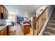 Open kitchen featuring wood cabinets, a center island, and a view of the staircase at 7244 Wild Oak Ln, Land O Lakes, FL 34637