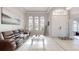 Spacious living room with high ceilings, arched windows, and decorative tile flooring at 7244 Wild Oak Ln, Land O Lakes, FL 34637
