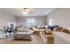 This living room features neutral carpets, a ceiling fan, and comfortable sofas at 7244 Wild Oak Ln, Land O Lakes, FL 34637