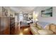 The main bedroom features hardwood floors, furniture, a ceiling fan, and natural lighting at 7244 Wild Oak Ln, Land O Lakes, FL 34637