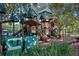 A wooden playground structure with multiple slides and play areas, nestled among mature trees at 7244 Wild Oak Ln, Land O Lakes, FL 34637