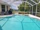 A screened-in pool with an attached spa and outdoor seating offers a refreshing retreat at 7244 Wild Oak Ln, Land O Lakes, FL 34637