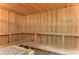 Warm wooden sauna with built-in benches, perfect for relaxation and rejuvenation in the community at 7244 Wild Oak Ln, Land O Lakes, FL 34637