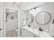 Updated bathroom features double sinks, granite vanity, and walk-in shower at 7630 Sailwinds Pass, Port Richey, FL 34668