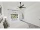Well-lit bedroom with a large window overlooking wooded area at 7630 Sailwinds Pass, Port Richey, FL 34668