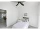 Cozy bedroom features vaulted ceiling, ceiling fan, and neutral decor at 7630 Sailwinds Pass, Port Richey, FL 34668