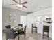 Dining room with a modern light fixture, seating for four, and breakfast bar area that connects to the kitchen at 7630 Sailwinds Pass, Port Richey, FL 34668