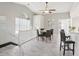 Dining area with seating for four, next to kitchen bar, and staircase at 7630 Sailwinds Pass, Port Richey, FL 34668