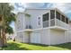 Beautiful home exterior with an elevated screened porch, offering a private outdoor space at 7630 Sailwinds Pass, Port Richey, FL 34668