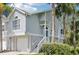 Charming two-story townhouse with a one-car garage, front steps and porch, and attractive tropical landscaping at 7630 Sailwinds Pass, Port Richey, FL 34668