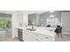 Open floor plan kitchen with stainless steel appliances, a breakfast bar, and easy access to other living areas at 7630 Sailwinds Pass, Port Richey, FL 34668