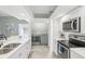 Contemporary kitchen with modern appliances and bonus laundry room, all in a pristine white design at 7630 Sailwinds Pass, Port Richey, FL 34668