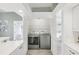 Convenient laundry room featuring washer and dryer, white cabinets, and ample storage space and natural lighting at 7630 Sailwinds Pass, Port Richey, FL 34668