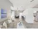 Open-concept living room featuring stylish furnishings, neutral paint and flooring, and adjacent dining and kitchen areas at 7630 Sailwinds Pass, Port Richey, FL 34668