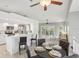 Open concept showing the kitchen bar, dining area, and bright and inviting living room at 7630 Sailwinds Pass, Port Richey, FL 34668