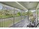 Inviting screened porch featuring comfortable seating and serene views of the surrounding landscape at 7630 Sailwinds Pass, Port Richey, FL 34668