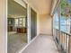 Balcony with sliding glass doors leading inside, with palm trees and waterfront views beyond at 7665 Sun Island Dr # 206, South Pasadena, FL 33707