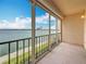 Enclosed balcony overlooking the blue waters of a bay, framed by buildings and clear sky at 7665 Sun Island Dr # 206, South Pasadena, FL 33707