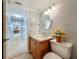 Cozy bathroom with neutral walls, wooden vanity, stone countertop, and tile flooring at 7665 Sun Island Dr # 206, South Pasadena, FL 33707