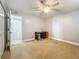Bright bedroom with neutral carpet, light walls, open closet, and a ceiling fan at 7665 Sun Island Dr # 206, South Pasadena, FL 33707