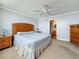 Bedroom features neutral walls, light carpet, wood furniture, and a ceiling fan at 7665 Sun Island Dr # 206, South Pasadena, FL 33707