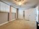 Bright bedroom with neutral carpet, light walls, mirrored closet, and a ceiling fan at 7665 Sun Island Dr # 206, South Pasadena, FL 33707