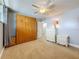 Bright bedroom with closet, neutral walls, ceiling fan, and an ensuite bathroom at 7665 Sun Island Dr # 206, South Pasadena, FL 33707