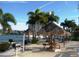 Waterfront grilling area with tiki huts, picnic tables, and grills for outdoor entertaining at 7665 Sun Island Dr # 206, South Pasadena, FL 33707
