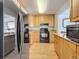 A view of the kitchen including black appliances, ample cabinetry, and wood flooring at 7665 Sun Island Dr # 206, South Pasadena, FL 33707