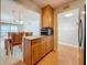 A kitchen with wood cabinets and a dining area in view at 7665 Sun Island Dr # 206, South Pasadena, FL 33707