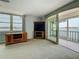 Inviting living room with a water view from the window and access to a private balcony at 7665 Sun Island Dr # 206, South Pasadena, FL 33707