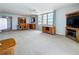 Open-concept living room featuring a dining area, large windows with a view, and a fireplace at 7665 Sun Island Dr # 206, South Pasadena, FL 33707