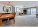Open-concept living and dining area with large windows and a sliding door to the balcony at 7665 Sun Island Dr # 206, South Pasadena, FL 33707