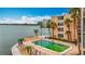 Community swimming pool with palm trees offering bay views in this desirable condo complex at 7665 Sun Island Dr # 206, South Pasadena, FL 33707