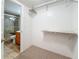 Walk-in closet with built in shelving and a view of the tiled shower in the bathroom at 7665 Sun Island Dr # 206, South Pasadena, FL 33707