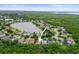 Aerial view of a residential neighborhood with a lake in the background at 826 Addison Ne Dr, St Petersburg, FL 33716
