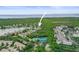 Beautiful aerial view of a community featuring a pool, tennis courts, and lake views at 826 Addison Ne Dr, St Petersburg, FL 33716