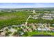 Aerial view of a residential neighborhood next to a lake with ocean views at 826 Addison Ne Dr, St Petersburg, FL 33716