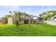 Scenic backyard view highlighting the screened-in pool area and meticulously maintained lawn at 826 Addison Ne Dr, St Petersburg, FL 33716