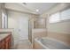 Well-lit bathroom featuring a walk-in shower and a separate soaking tub at 826 Addison Ne Dr, St Petersburg, FL 33716