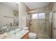 Elegant bathroom featuring glass bowl sink, granite countertops, and a glass-enclosed shower at 826 Addison Ne Dr, St Petersburg, FL 33716