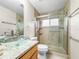 Bright bathroom featuring granite countertops, glass vessel sink, and glass-enclosed shower at 826 Addison Ne Dr, St Petersburg, FL 33716