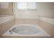 Close-up on the soaking tub featuring neutral tile and sleek fixtures at 826 Addison Ne Dr, St Petersburg, FL 33716