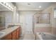 Bright bathroom showcasing a shower, soaking tub and double sink vanity at 826 Addison Ne Dr, St Petersburg, FL 33716