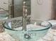 Close-up of a glass vessel sink atop a granite countertop with modern faucet fixtures at 826 Addison Ne Dr, St Petersburg, FL 33716